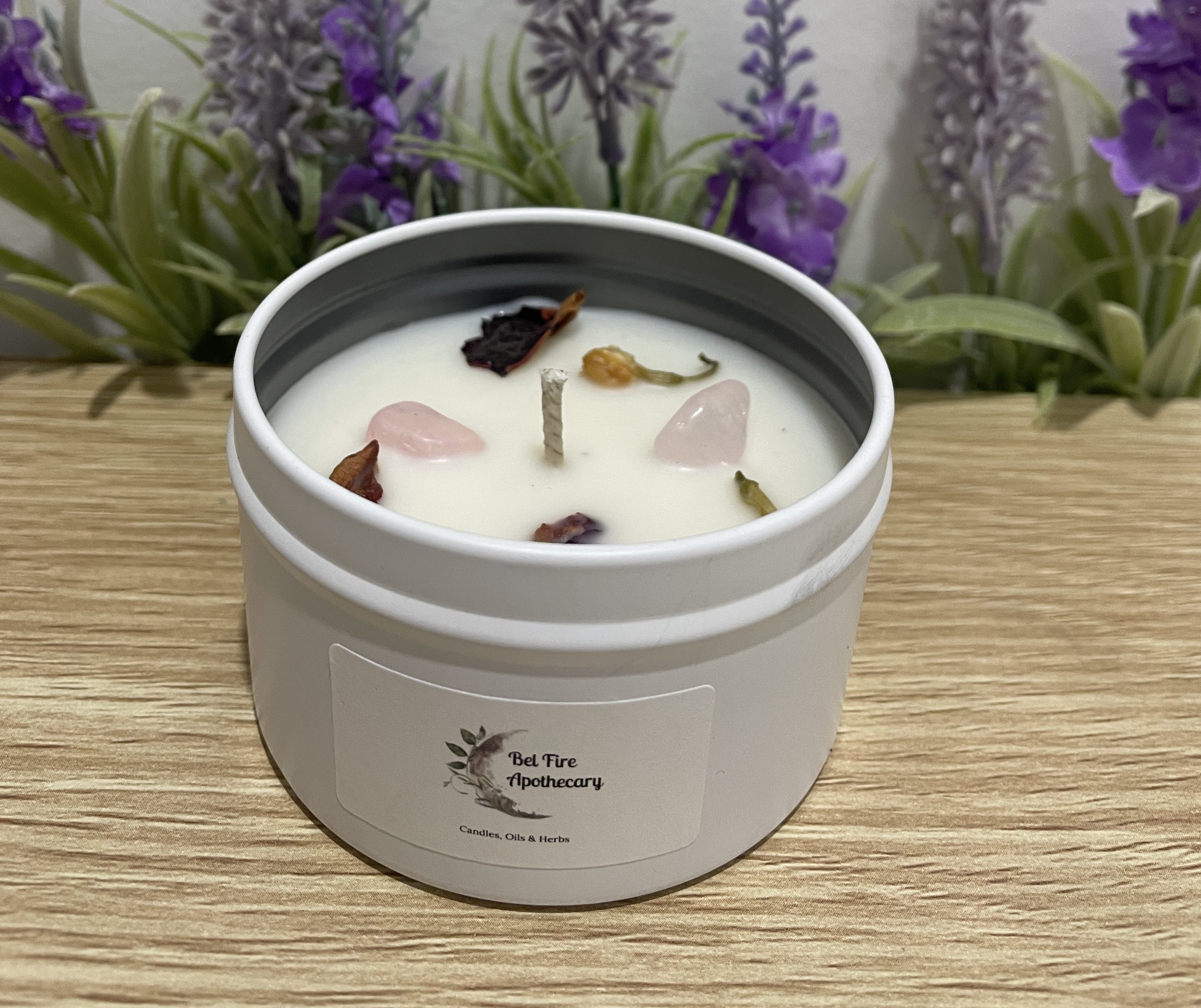 White tin soy candle with rose quartz crystals and dried botanicals
